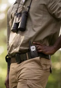 A ranger on patrol with radio and binoculars